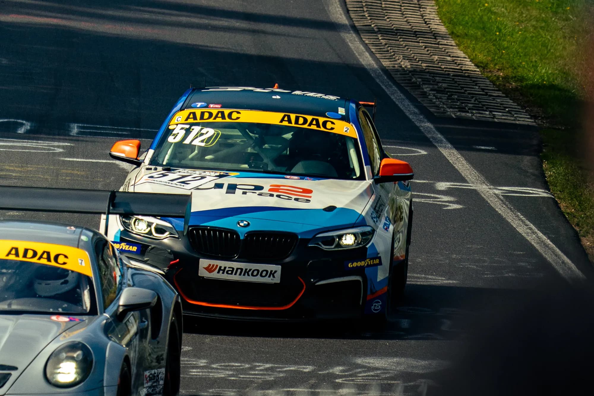 The BMW M240i Racing #512 ahead of a Porsche during RCN 7